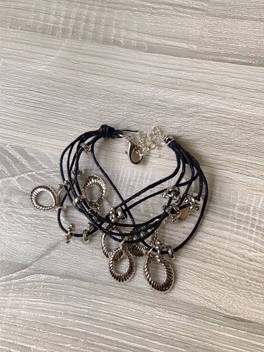 Multistrand bracelet with charms on a textured surface