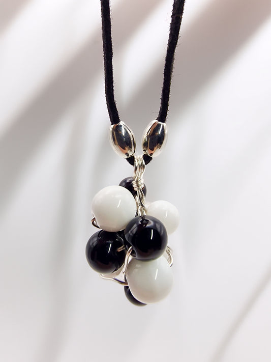 Necklace with black and white beads on a light background