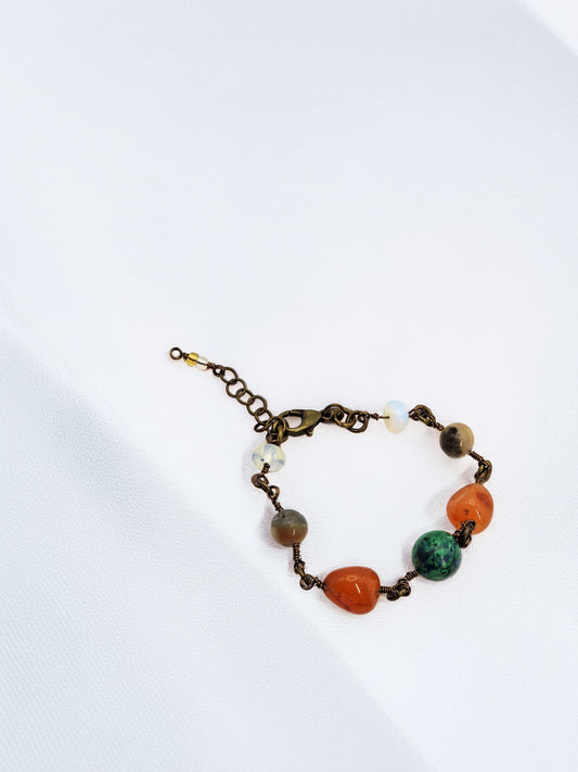 Bracelet with multicolored stone beads on a white background