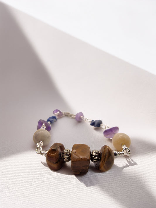 Jewelry bracelet with various beads on a light background